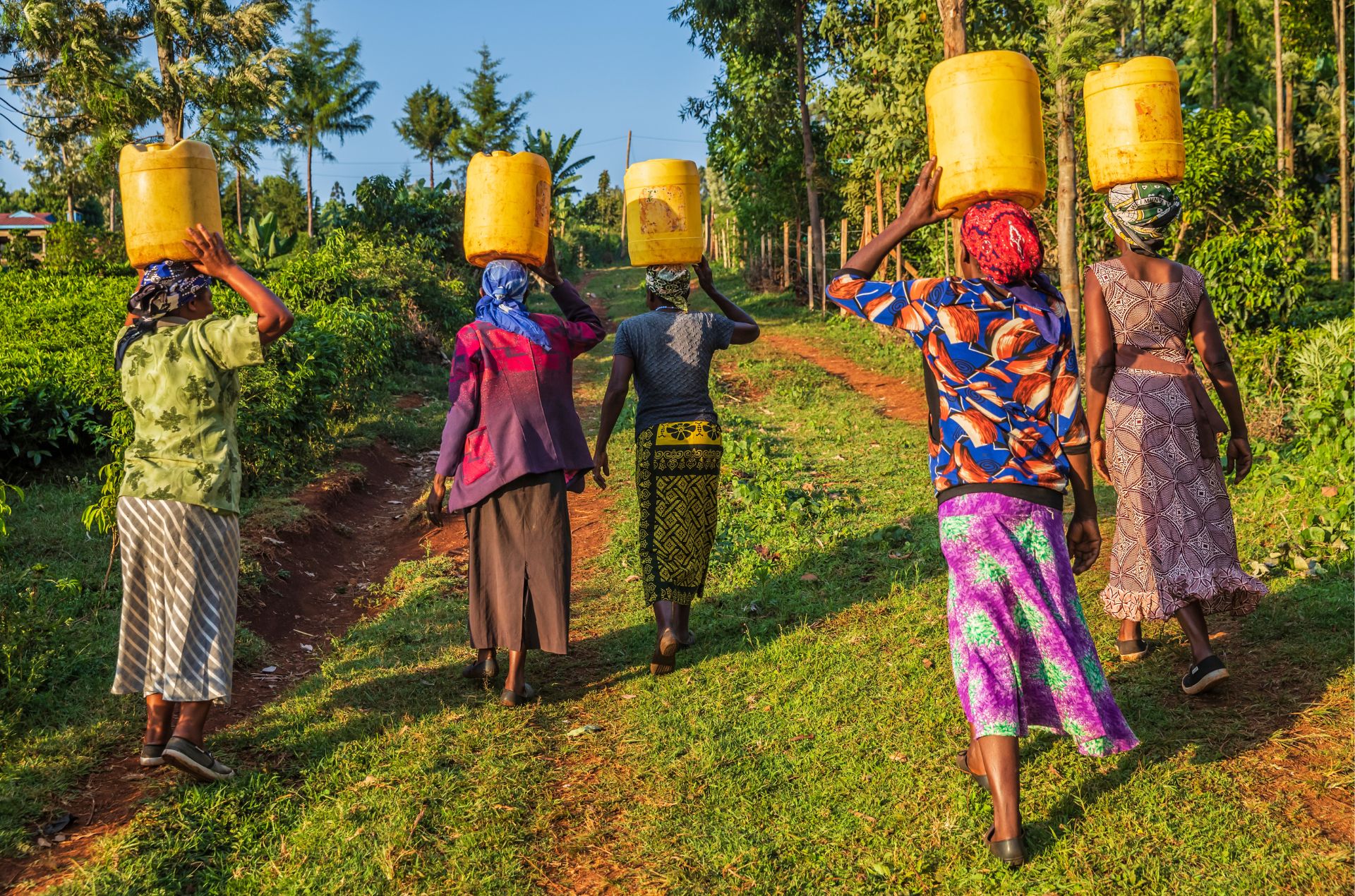 Kenya women walking with water